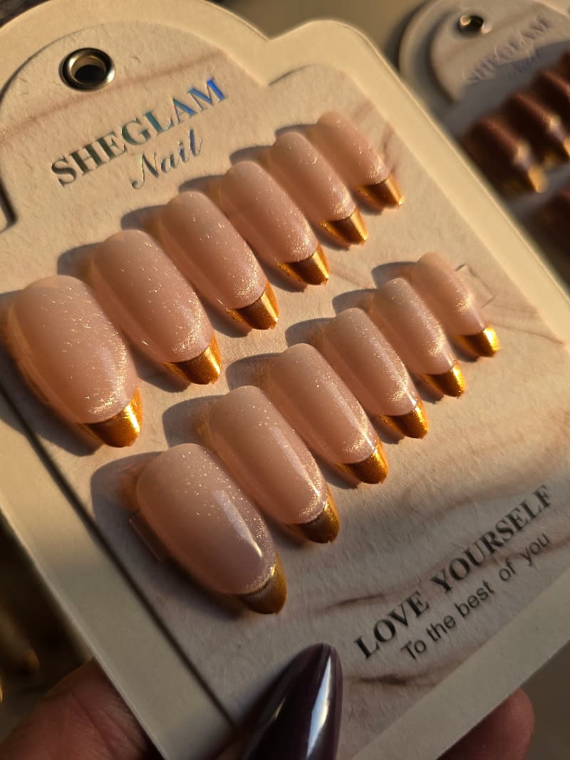 Colorful nails with gold french tip .