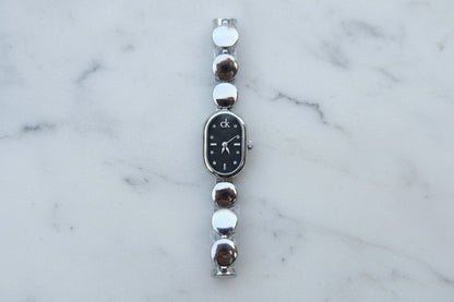 Silver C-K watch (which, black)and mix silver X gold with black Dial.