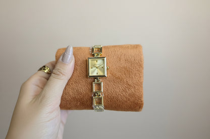Gold open square watch with gold dail