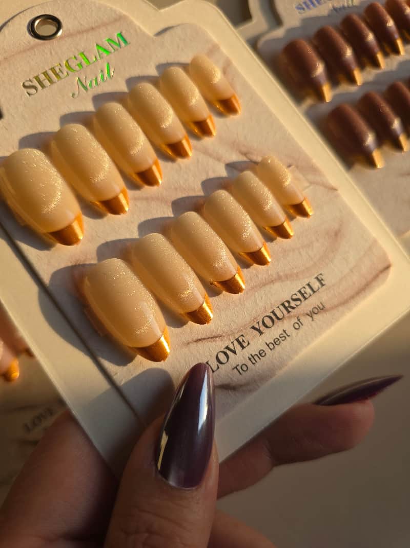 Colorful nails with gold french tip .