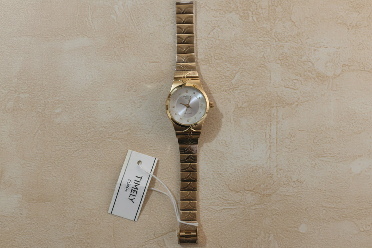 Gold Timely rain watch with white dial.