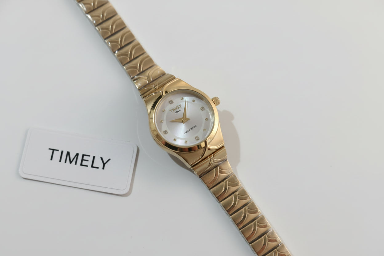 Gold Timely rain watch with white dial.