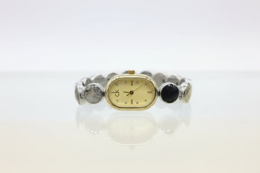 Oval C-K mix gold X silver watch with light gold dail