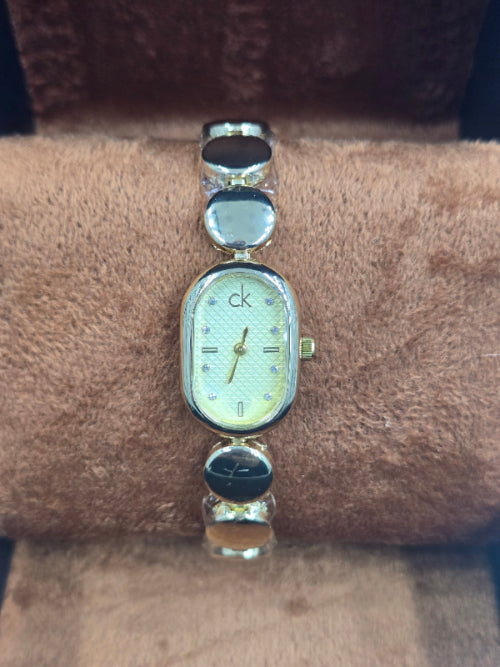 Oval C-K mix gold X silver watch with light gold dail