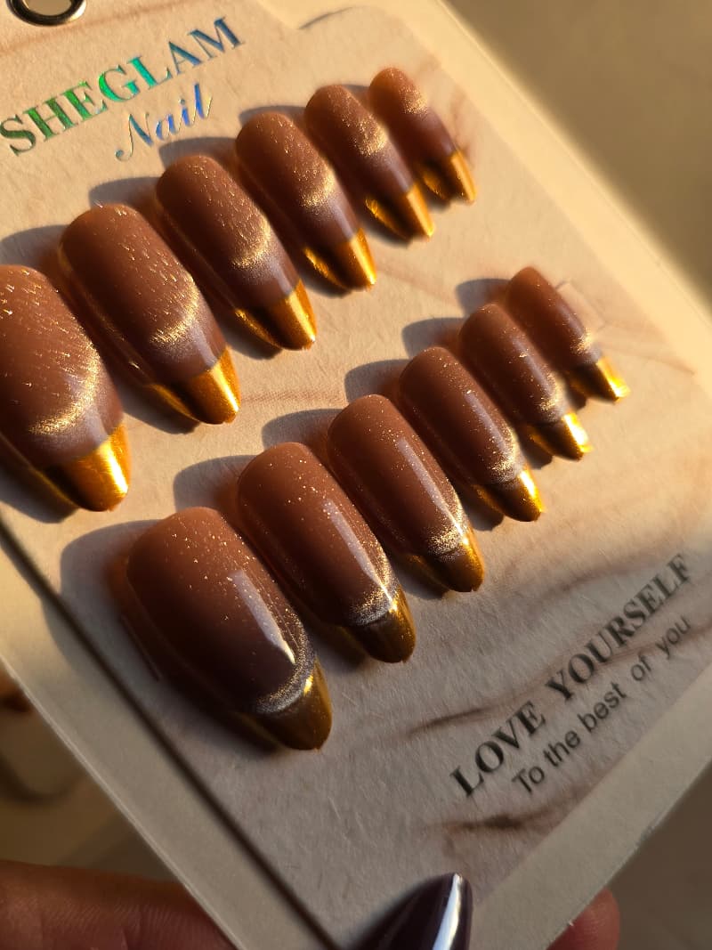 Colorful nails with gold french tip .