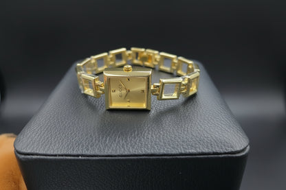 Gold open square watch with gold dail