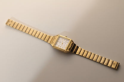 Gold Timely Rain gold watch with white dial.